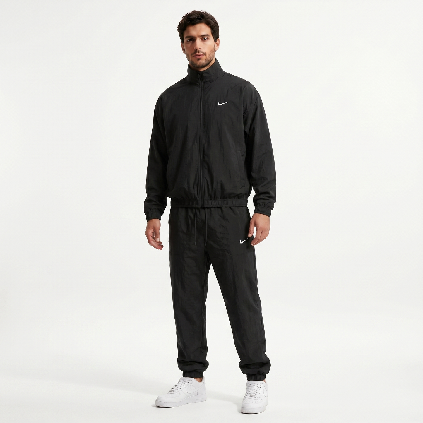 Nike NOCTA Track Complete tracksuit in Black - model wearing full outfit, front view